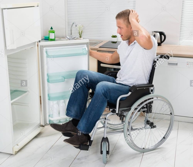 young-man-on-wheelchair-looking-in-empty-refrigerator-KAENHA